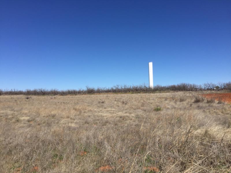 Water tower in pasture